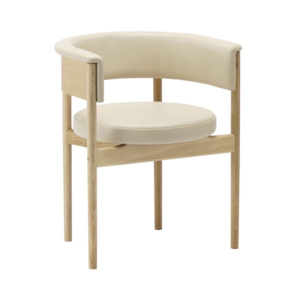 Circa Dining Armchair against a white background. The chair has a light-toned wooden frame with a curved backrest and a circular seat, both upholstered in a smooth, cream-colored fabric. The design is minimalist and modern, with slender, straight legs and clean lines, highlighting the chair's elegant and contemporary aesthetic.