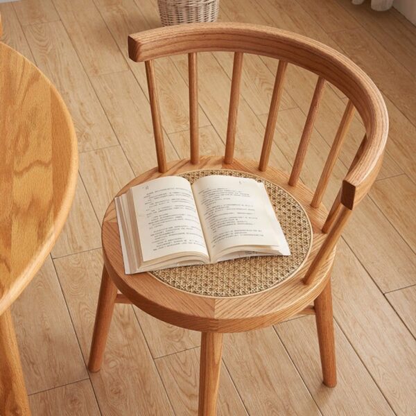 Eberly Wood Dining Chair positioned in a cozy corner with a book, blending comfort with style in home decor