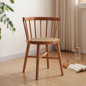 Side view of Eberly Wood Dining Chair in a natural setting, highlighting its sturdy beech wood legs and rattan seat.