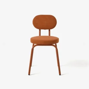 A front view of the Lucinda Steel Dining Chair, featuring a rust-colored steel frame with a round seat and backrest upholstered in textured orange-brown fabric