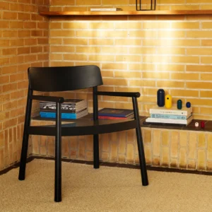 Tobi ash wood armchair in black in a minimalistic interior setting