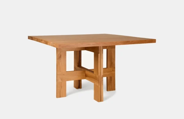 Granny oak dining table finished in oil in natural color in front of a white background