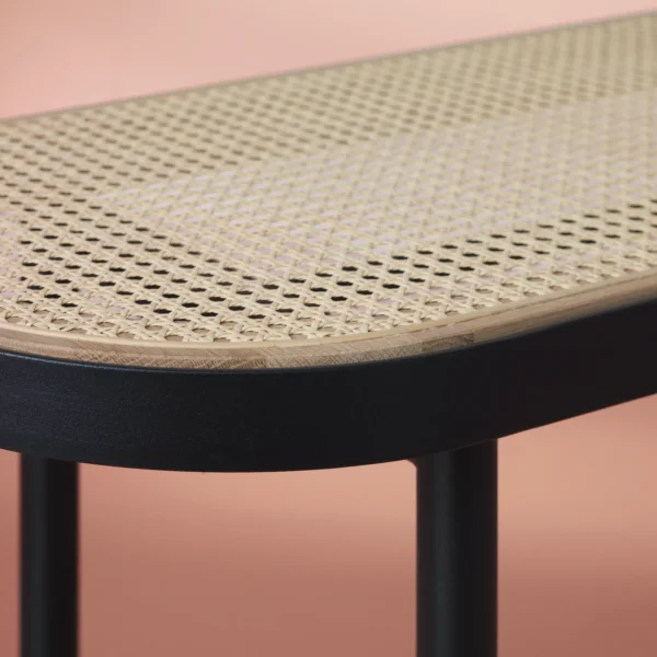 close up view of the tray rattan bench in a pink background