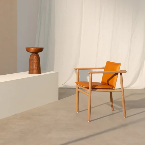 Iggy armchair with a natural wood frame, available in oak and beech. The chair features burnt orange upholstery