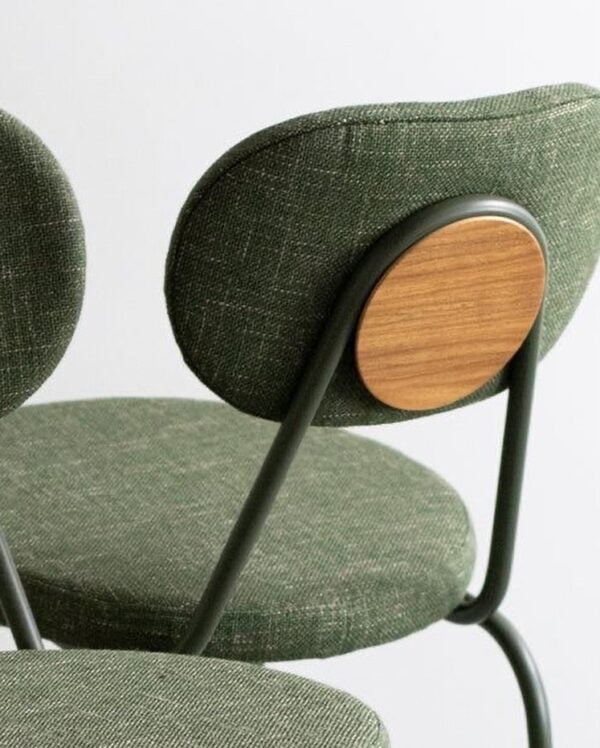 close up shot of the rear marisol steel bar chair showing the details of upholstery and steel finishing