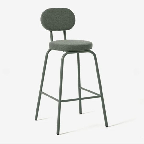 Side view of the lucinda bar chair, in green paint,Backrest and seat pad are upholstered in a matching green fabric. The bar chair is placed in front of clean minimalistic white background