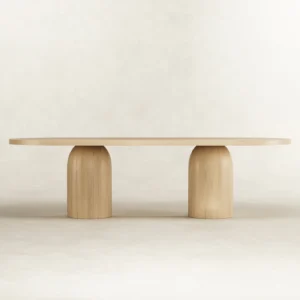 Oval dining table crafted in Lebanon from solid ash wood and ash veneer, set on sculpted two bullet-shaped bases for a striking minimalist design.