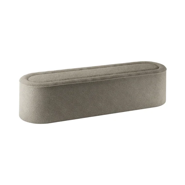 Nel Upholstered Bench in a muted grey, showcasing a smooth, elongated oval shape with plush fabric and minimalist design