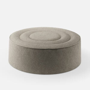 Round pouf in light gray fabric, featuring a minimalist design with concentric circular stitching on the top surface