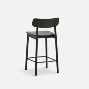 Isolated view of the Yuri counter stool, featuring a sleek black ash veneer seat and solid ash legs with a minimalist design, ideal for modern bars and kitchen counters