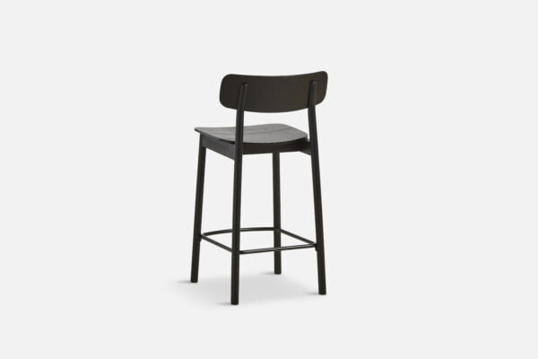 Isolated view of the Yuri counter stool, featuring a sleek black ash veneer seat and solid ash legs with a minimalist design, ideal for modern bars and kitchen counters