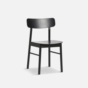 angled view of yuri dining chair, unupholstered in black oak