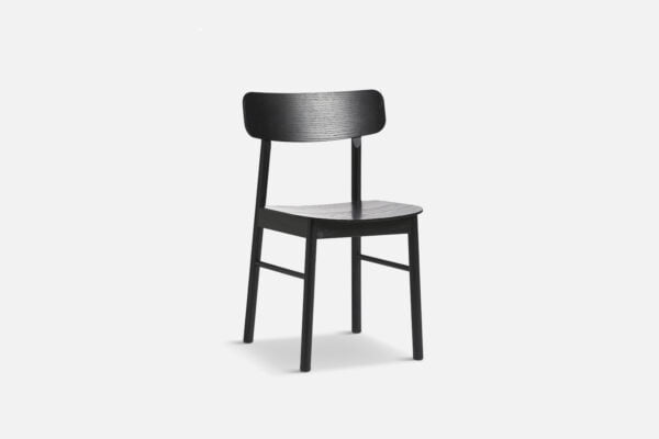 angled view of yuri dining chair, unupholstered in black oak