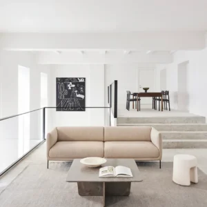 Nu sofa by Kersetna Lebanon, a modern minimalist beige sofa with soft curves and slim black metal legs, displayed in a contemporary living room with neutral tones, perfect for a stylish and comfortable setting