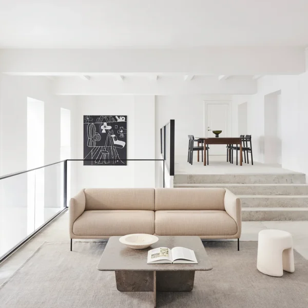 Nu sofa by Kersetna Lebanon, a modern minimalist beige sofa with soft curves and slim black metal legs, displayed in a contemporary living room with neutral tones, perfect for a stylish and comfortable setting