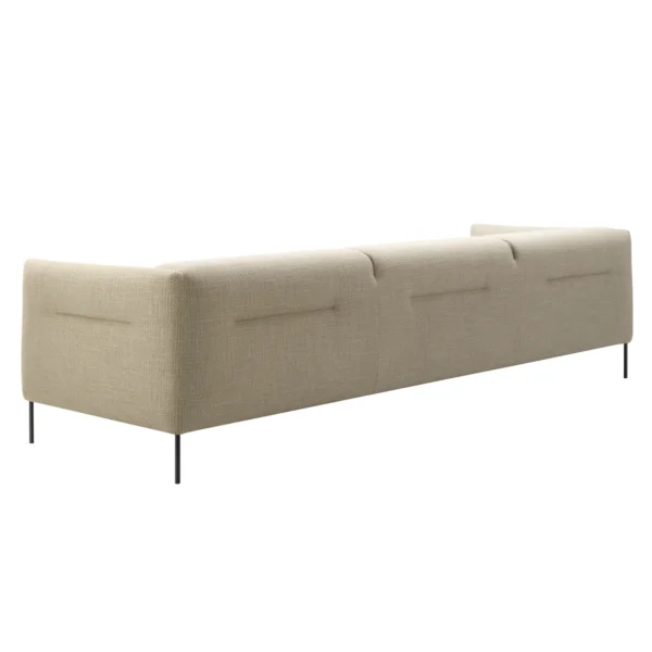 Side view of Nu three seater sofa in beige upholstery in front of a white background