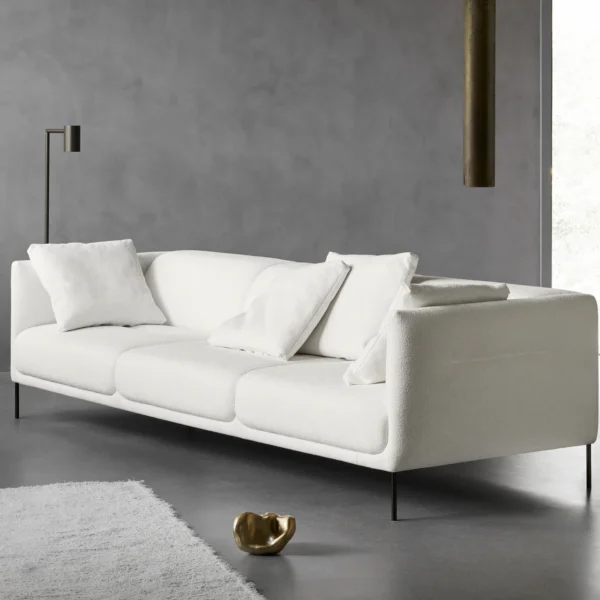 Nu three seater sofa, upholstered in white fabric, with cushions on the seat, in a brutal interior, made by Kersetna Lebanon