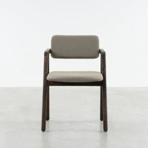 Jude dining armchair front view, jude is made out of solid oak , stained in a walnut finish and and cushioned seat and backrest upholstered in a boucle fabric