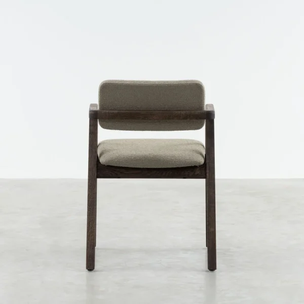 Jude dining armchair rear view, jude is made out of solid oak , stained in a walnut finish and and cushioned seat and backrest upholstered in a boucle fabric