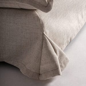 Close-up of the linen slipcover with pleated detailing on the Lynn Lounge Chair