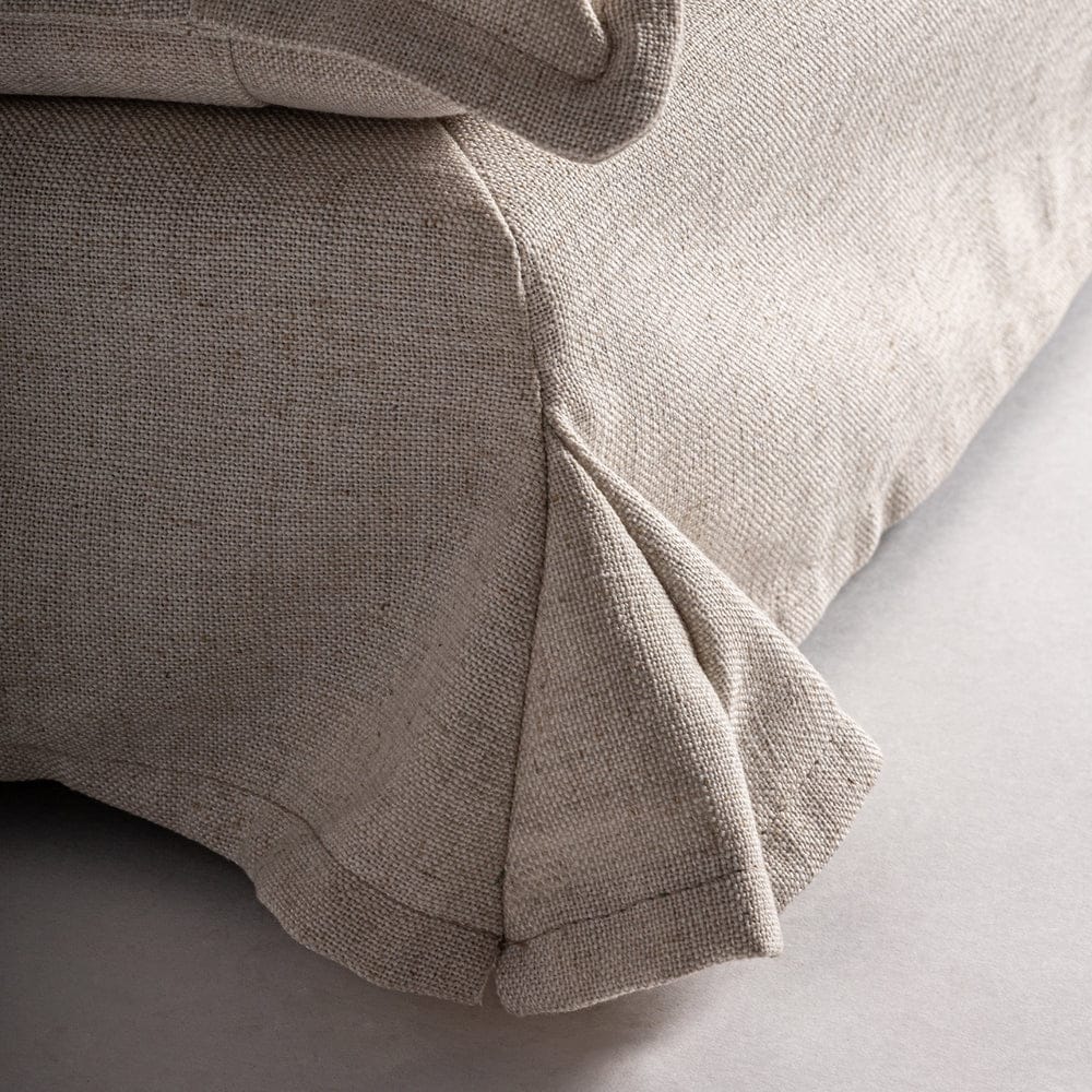 Close-up of the linen slipcover with pleated detailing on the Lynn Lounge Chair