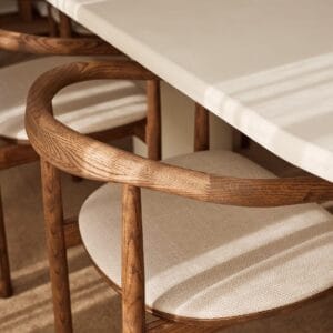 Close-up image of the handcrafted wooden curved backrest of emma dining chair