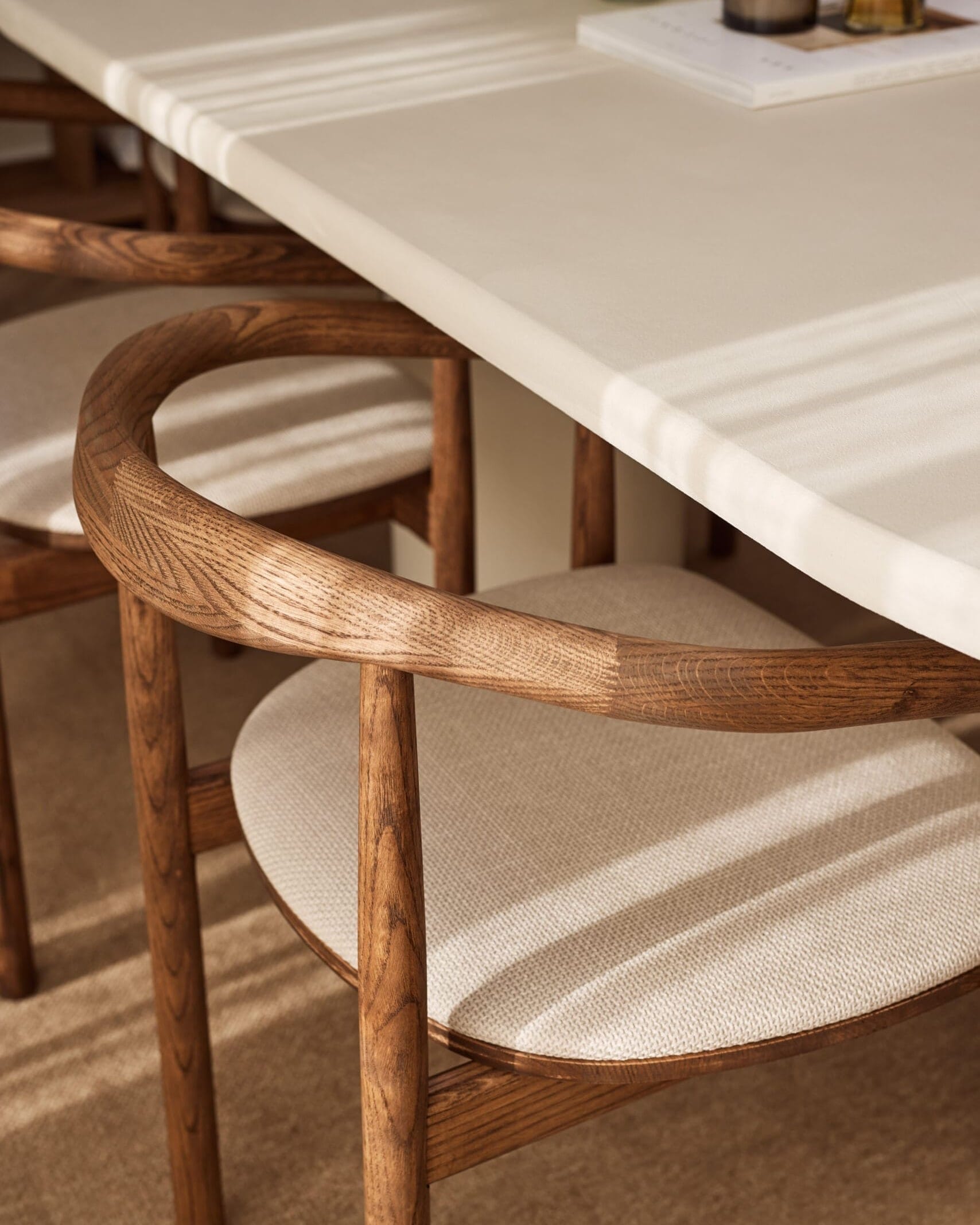 Close-up image of the handcrafted wooden curved backrest of emma dining chair