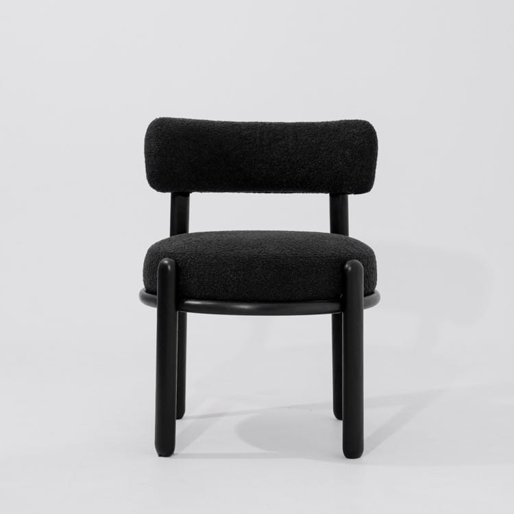 Front view of Minuit dining chair, frame made of solid wood painted in black , Backrest and seat-pad are both cushioned and upholstered in black boucle fabric, handcrafted by kersetna in lebanon