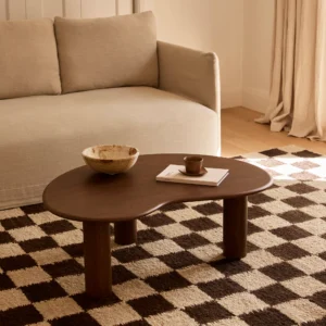 Olly coffee table , organic table top shape, resting on 3 cylindrical legs, handcrafted in solid oak and oak veneer finished in a walnut stain by kersetna in lebanon