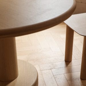 Top view of allure dining table showing the french oak top veneer and the solid wood base, aesthetic image shown in a beautiful interior